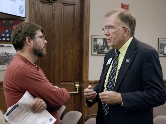 Steve Talking With Man In Red