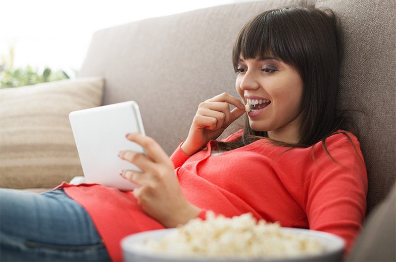 Woman watching TV on tablet