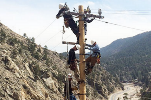 Technicians hanging aerial fiber lines in Big Thompson Canyon