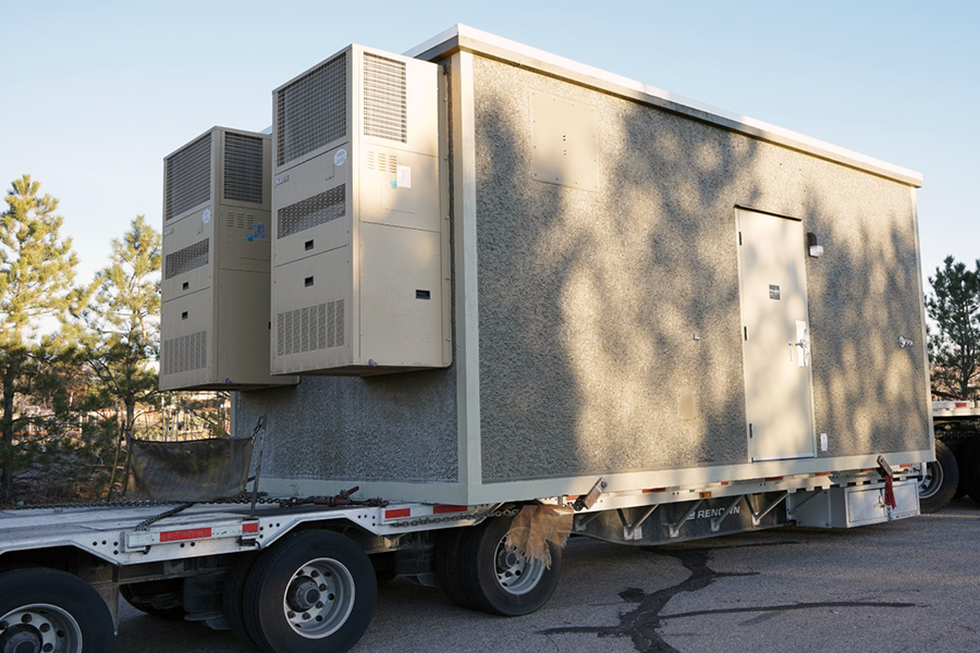 Image of fiber hut arriving on a tractor trailer